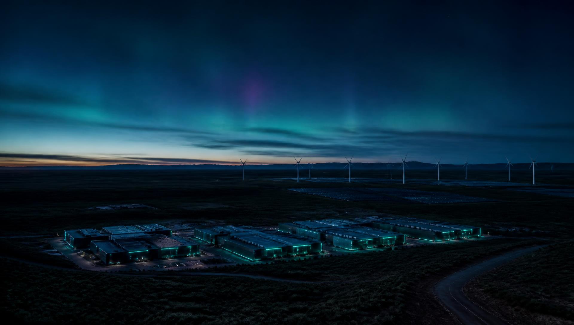 Twilight view of low-rise research and compute infrastructure beneath an aurora sky in Western Australia
